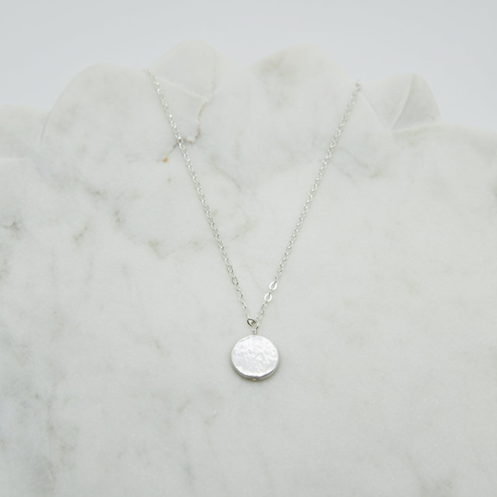 large white coin pearl necklace on a silver chain.