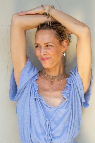 Silver Jetsetter drop necklace layered with two simple chokers one is chain and one is beaded.