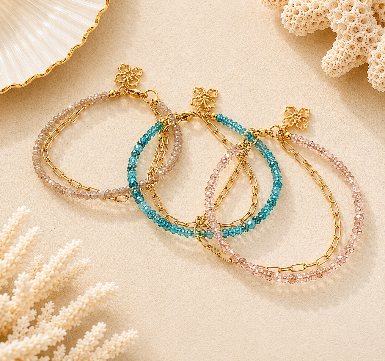 Three beaded and chain bracelets on a sandy background