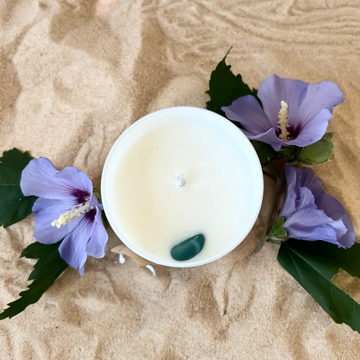 Payton Beach Lotion Candle pictured from the top down where you can see a beautiful teal piece of sea glass in the white soy wax.