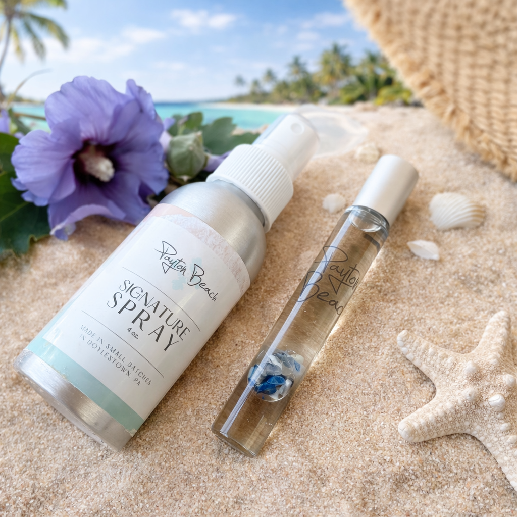 A bottle of our signature spray and our aromatherapy roller shown as a set on the beach.
