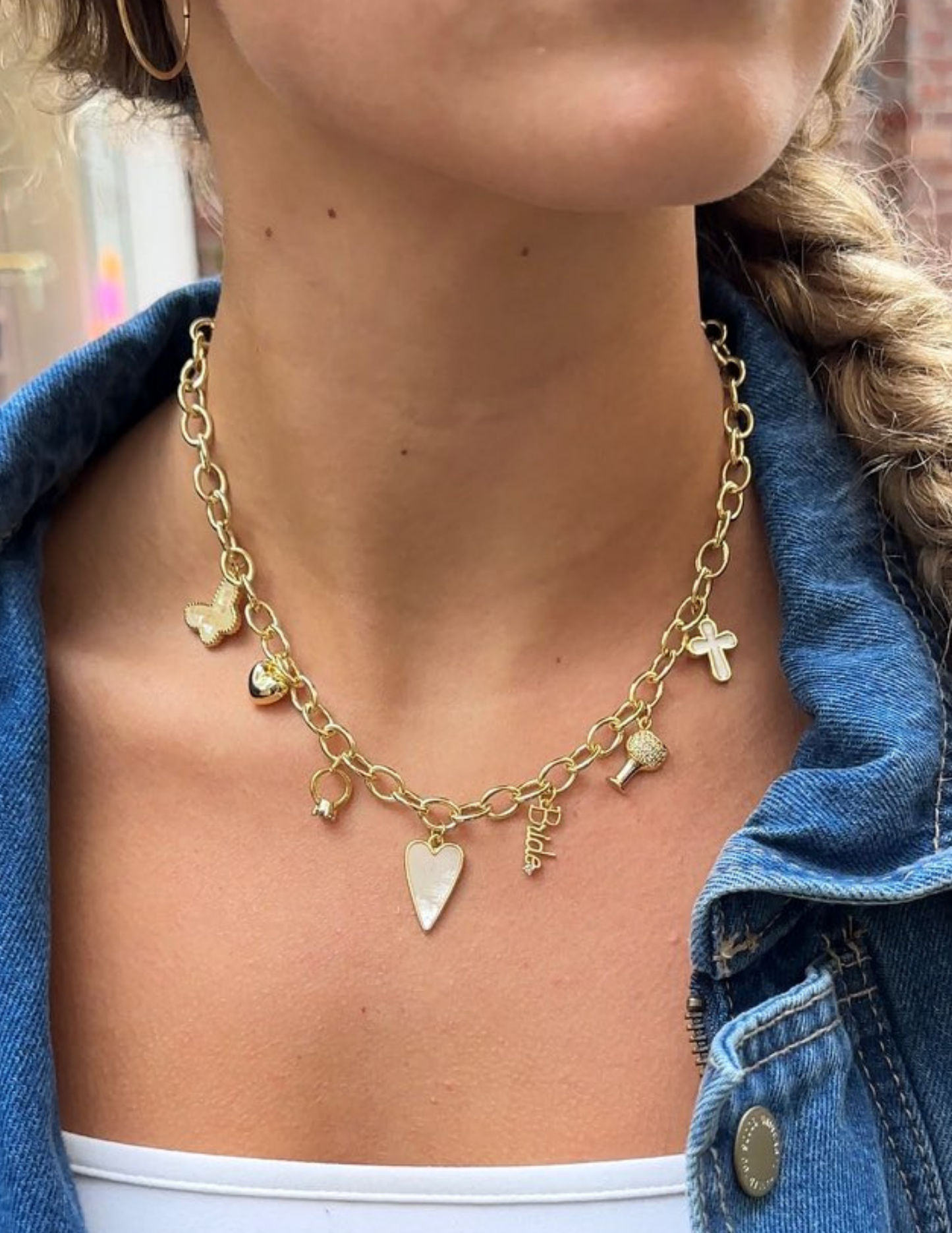 A picture of a woman wearing a bride themed charm necklace from our charm bar.