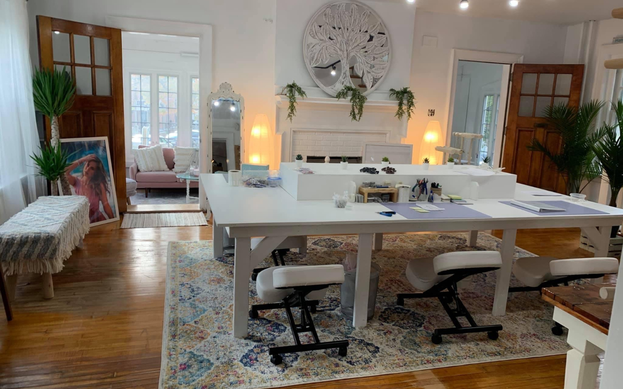 Our doylestown jewelry studio with a large makers table set up and coastal boho decor.