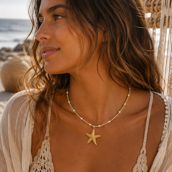 Woman wearing a starfish necklace on a beach