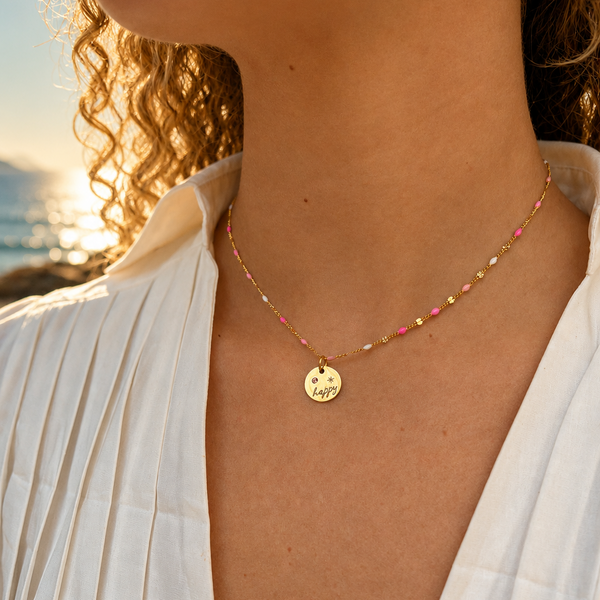 Necklace with a small round pendant worn by a person with a blurred background