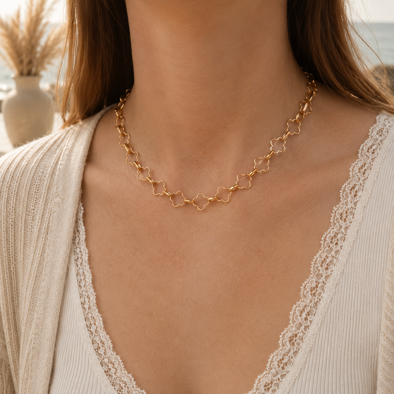 Close-up of a gold chain necklace worn by a person with a blurred background