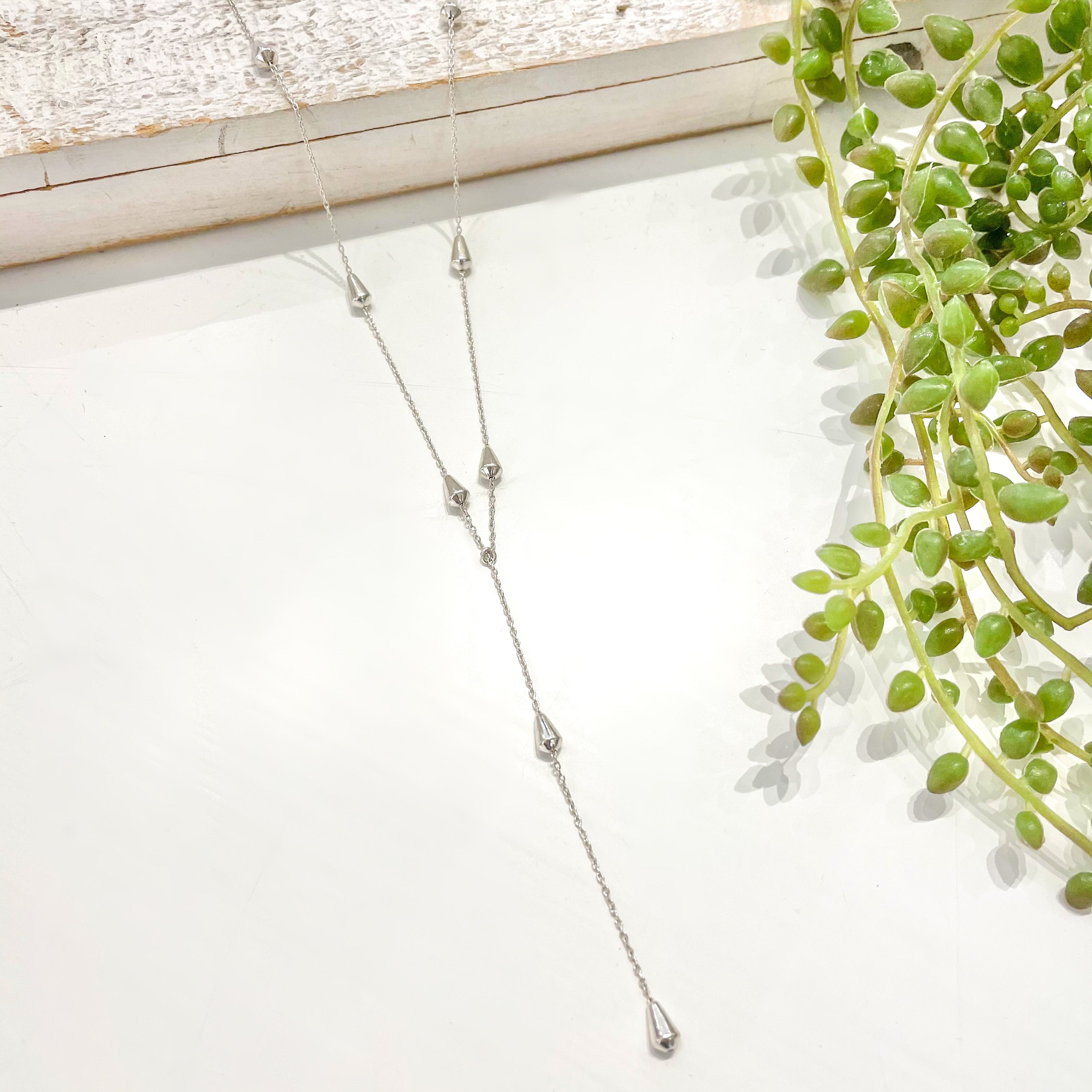silver teardrop beaded chain drop style necklace.