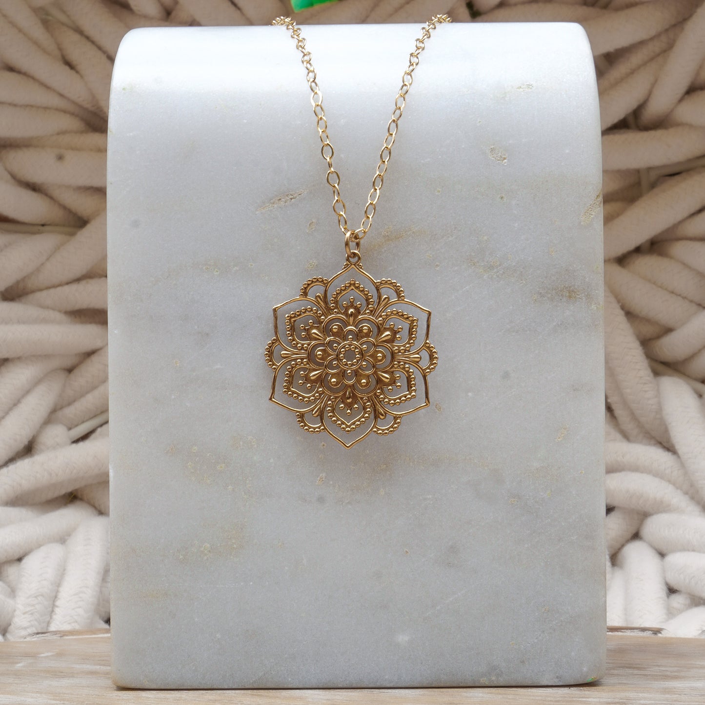 intricately detailed open mandala pendant necklace in gold fill.